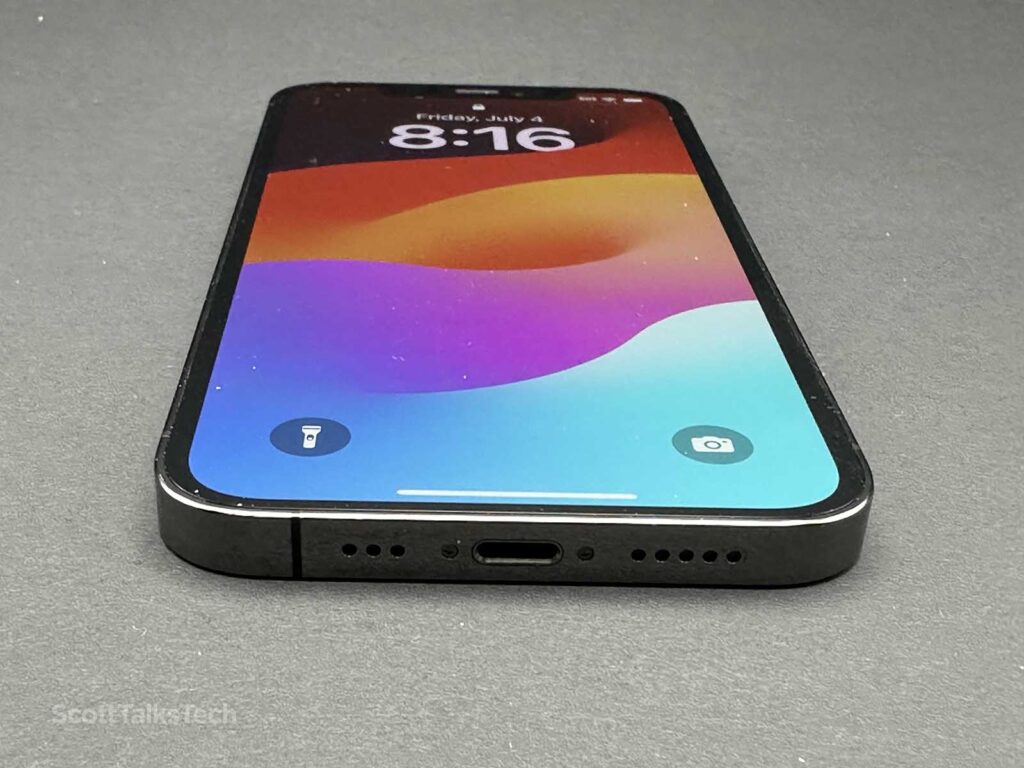 Space gray Apple iPhone 12 Pro lying face up a showing bottom edge