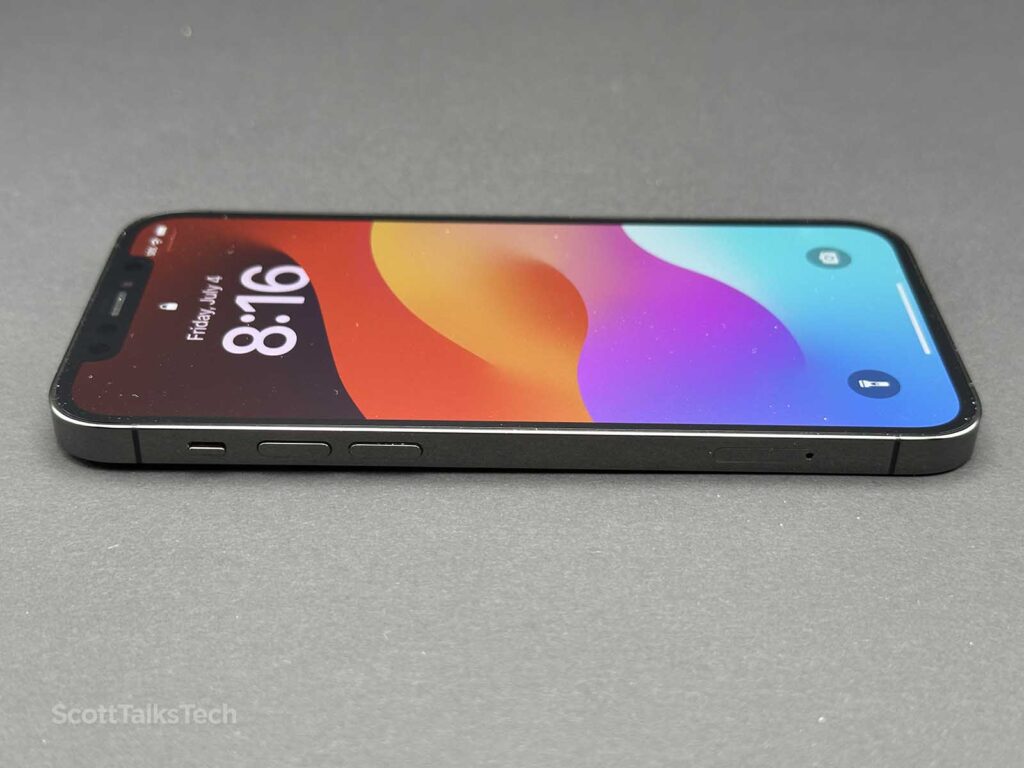 Space gray Apple iPhone 12 Pro lying face up showing side rail