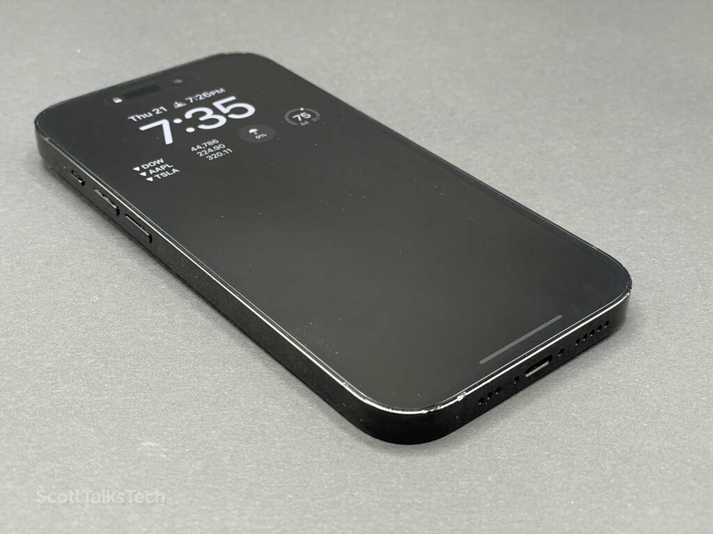Space Black iPhone 14 Pro lying face up up with always on display showing time