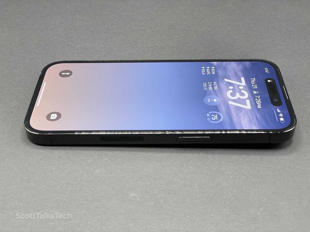 Space Black iPhone 14 Pro lying up with screen on showing lock screen